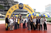 Jubilant connections of Rewarding Hero celebrate their victory after the race.