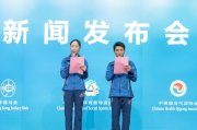 Olympic race walking champion Wang Liping (left) and acrobatics champion Teng Haibin pledge their voluntary services for the Programme.