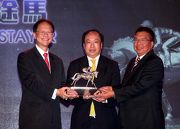 Mr Philip N L Chen, Steward of The Hong Kong Jockey Club, presents the trophy to the representatives of the 10/11 John Moore Trainer Syndicate, owner of Champion Stayer Dominant.