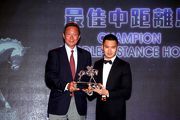 Dr Simon S O Ip, Deputy Chairman of The Hong Kong Jockey Club, presents the trophy to the owner representative of Champion Middle-Distance Horse Designs On Rome.