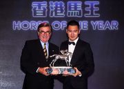 Photos 14, 15: DESIGNS ON ROME is crowned Horse of the Year. Mr T Brian Stevenson, Chairman of The Hong Kong Jockey Club, presents the trophy to the owner representative Mr Carlson Cheng.
Jockey Tommy Berry, trainer John Moore and his son George join for a group photo after the presentation ceremony.