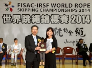 The Club's Head of Charities Projects Rhoda Chan (right) receives a souvenir from FISAC-IRSF World Rope Skipping Championships 2014 Organising Committee Chairman Dr Patrick Ko (left) at the opening ceremony.