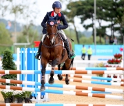 Former Club Riding Instructor Nicole Pearson, pictured here in the jumping competition, performs steadily throughout to help the team to win a medal. 