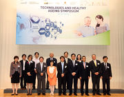 The Cluba?s Executive Director, Charities and Community Leong Cheung (front row, 3rd right) pictured with Under Secretary for Labour and Welfare Stephen Sui (front row, centre), Chairman of the ASTRI Board Wong Ming-yam (front row, 4th right), CUHK Pro-Vice-Chancellor Professor Fanny Cheung (front row, 4th left), Elderly Commission Chairman Professor Alfred Chan (front row, 3rd left), Jockey Club CADENZA Project Director and CUHK Jockey Club Institute of Ageing Director Professor Jean Woo (front row, 2nd left), International Society for Gerontechnology President Professor Alain Franco (front row, 2nd right), CEO of Singaporea?s Integrated Health Information Systems Pte Ltd Dr Chong Yoke-sin (front row, 1st left) and other guests at the Technologies And Healthy Ageing Symposium.