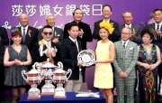 At the Sa Sa Ladies�� Purse trophy presentation ceremony, Miss Elaine Leung Wai Yin, daughter of the Club��s Steward Mrs Margaret Leung, presents a silver dish to Lee Man Yan, Owner of Packing Llaregyb.