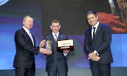 Mr Winfried Engelbrecht-Bresges, Vice-Chairman (Asia) of the International Federation of Horseracing Authorities and Chief Executive Officer of the Hong Kong Jockey Club (left), and Mr Juan-Carlos Capelli, Vice President of LONGINES and Head of International Marketing (right), co-present a trophy to Mr Ryan Moore, LONGINES World��s Best Jockey in 2014, at the gala dinner of the LONGINES Hong Kong International Races held tonight at the Hong Kong Convention & Exhibition Centre.