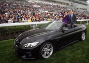 Photo 16, 17, 18, 19: Three BMW convertibles carry the owner, trainer and jockey of BMW Hong Kong Derby winner LUGER for a parade on the turf track after the trophy presentation ceremony.