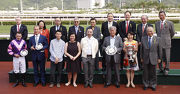 HKJC Chairman Dr Simon S O Ip, HKJC Stewards, Chief Executive Officer Winfried Engelbrecht-Bresges, and winning connections of Dundonnell, all smile for a photo at the Sprint Cup trophy presentation ceremony.