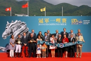 Dr Simon S O Ip, Chairman of HKJC; Club Stewards; Mr Winfried Engelbrecht-Bresges, CEO of HKJC; and the winning connections of Able Friend smile for cameras at the Champions Mile trophy presentation ceremony.