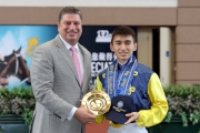 To celebrate the apprenticeship graduation of Alvin Ng and his promotion to Freelance Jockey, William A Nader, Executive Director of Racing of The Hong Kong Jockey Club, presents a souvenir to Alvin Ng at the apprentice jockey graduation ceremony held at Sha Tin Racecourse today.