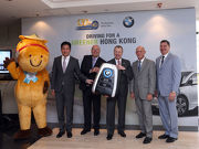 The Cluba?s Chief Executive Officer Winfried Engelbrecht-Bresges (3rd right), Executive Director of Information Technology and Sustainability Christoph Ganswindt (2nd right), Executive Director of Racing William A Nader (1st right), BMW Group Importer Office HK, Macau and Taiwan Vice President Kevin Coon (3rd left), BMW Concessionaires (HK) Ltd & Sime Darby Motor Group (HK) Limited Managing Director- Hong Kong and Macau Newman Tsang (2nd left) and the Cluba?s Progressing Together Cheering Team Member Ms Green (1st left) officiate the a?HKJC x BMW Electric Vehicles - Driving for a Greener Hong Konga? Ceremony to celebrate the new fleet handover.