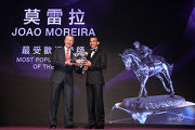 Joao Moreira, voted the Most Popular Jockey of the Year, receives the trophy from Mr Winfried Engelbrecht-Bresges, CEO of The Hong Kong Jockey Club.