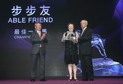 Mr Lester C H Kwok, Steward of The Hong Kong Jockey Club, presents the trophy to Dr & Mrs Cornel Li, owner of Champion Miler Able Friend. 