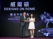 Mr Anthony W K Chow, Deputy Chairman of The Hong Kong Jockey Club, presents the trophy to Mrs Cheng Keung Fai, owner of Champion Middle-Distance Horse Designs on Rome.