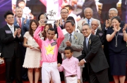 Joao Moreira, Champion Jockey for the 2014/15 racing season, receives his trophy from Anthony Chow, Deputy Chairman of the Club.