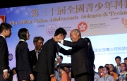 Club Steward The Hon Sir C K Chow (right) presents awards to winning students.