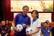 Manchester United legend Bryan Robson cheers on girl footballers at the launch ceremony.