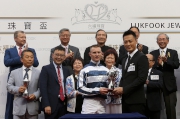 Raymond Lam, the spokesperson of Love Forever collection, presents a miniature to the winning jockey Zac Purton.