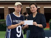Before the race, Karen Au Yeung (right), Vice President of LONGINES HK, presents a HK$2,000 prize to the Stables Assistant responsible for Top Act, the best turned out horse in the LONGINES Jockey Club Cup.
