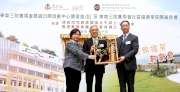 Club Steward Dr Eric Li Ka Cheung (centre) receives a souvenir from Secretary for Justice Rimsky Yuen (right) and TWGHs Chairman Maisy Ho (left).