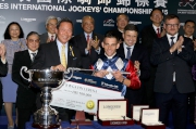 Dr Simon S O Ip, Chairman of the HKJC, presents a silver whip and cash prize of HK$500,000 to Gavin Lerena, winner of the LONGINES International Jockeys' Championship.