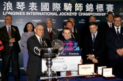 Mr Anthony W K Chow, Deputy Chairman of the HKJC, presents a silver dish and cash prize of HK$200,000 to Ryan Moore, first runner-up of the LONGINES International Jockeys' Championship.