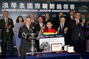 Mr Anthony W K Chow, Deputy Chairman of the HKJC, presents a silver bowl and cash prize of HK$100,000 to Keita Tosaki, second runner-up of the LONGINES International Jockeys' Championship.