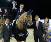 Bertram Allen from Ireland claims the Hong Kong Jockey Club Trophy. Club Chairman Dr Simon Ip (second right) and Club Steward and President of Hong Kong Equestrian Federation Michael Lee (first left) present the trophy to the champion.