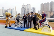 Olympic windsurfing gold medalist Lee Lai-shan (2nd left) and Head Coach of Manchester United Soccer Schools in Hong Kong Christopher Oa?Brien (1st right) ride the cycling power generator to showcase their sports power. 