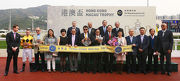 Stewards of the HKJC; Angela Leong, Vice Chairman and Executive Director of the Macau Jockey Club (front row, 5th from right); top executives of the HKJC and MJC; and the connections of Hong Kong Macau Trophy winner Dashing Fellow, pose for a group photo at the trophy presentation ceremony.