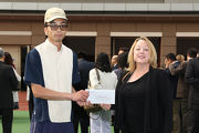Before the race, Heidi Lester, Chief Stipendiary Steward of the Macau Jockey Club, presents a prize of HK$2,000 to the Stable Assistant responsible for Apollo��s Choice, the Best Turned Out Horse in the Hong Kong Macau Trophy.
