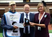 Kevin Coon (centre), Vice President of BMW Group Importer Office HK, Macau & Taiwan, presents a prize and a souvenir to the stables assistant responsible for Werther, the best turned out horse in the BMW Hong Kong Derby, in the Parade Ring before the race.