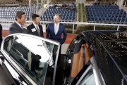 Officiating guests have a look at the BMW sedan cars on display in the parade ring of Sha Tin Racecourse today.