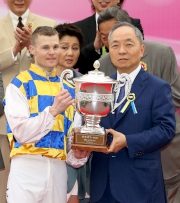 澳門賽馬會董事總經理李志強先生（右）頒發澳港盃獎盃予頭馬「好有運」的騎師卡爾德。