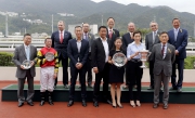Club Chairman Dr Simon Ip, Club Stewards, CEO Winfried Engelbrecht-Bresges, and the connections of The Sprint Cup winner Lucky Bubbles, smile for cameras at the presentation ceremony.