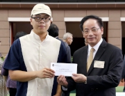 Member of the Executive Council and the Legislative Council (District Council aᡧ First) the Hon Ip Kwok-him (right) presents the Best Turned Out Horse award to the Stables Assistant responsible for Penny Lane (left).