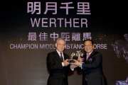 Mr Anthony W K Chow, Deputy Chairman of The Hong Kong Jockey Club, presents the trophy to Mr Johnson Chen, owner of Champion Middle-Distance Horse Werther.