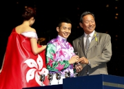 Photo 3, 4, 5<br>
Dr Simon S O Ip, Chairman of the Club, presents a silver goblet to each of the 12 participating jockeys.

