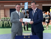Before the race, Mr Jim Gagliano, Vice Chairman of the International Federation of Horseracing Authorities, presents a prize of HK$5,000 to the stable representative of Silverwave, the Best Turned Out Horse in the LONGINES Hong Kong Vase.