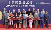 Dr Simon Ip (front row, third from right), Chairman of the Hong Kong Jockey Club, Club Stewards, CEO Winfried Engelbrecht-Bresges (front row, second from right), and the connections of race winner Lucky Bubbles, smile for cameras in the Chairman��s Sprint Prize trophy presentation ceremony.