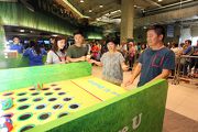 Father and son play at game booth to celebrate Father��s Day. 