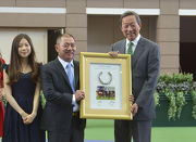 Owner Cheng Keung Fai presents a framed Designs On Rome horseshoe to the Hong Kong Jockey Club Chairman Dr Simon Ip.