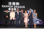 Rapper Dragon is crowned Horse of the Year. Dr. Simon Ip, Chairman of HKJC, presents the trophy to owner Mr. Albert Hung Chao Hong, accompanied by trainer John Moore, jockey Joao Moreira and Mr. Hung��s family.