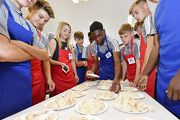 Photo 5 and 6: Manchester United Academy U16 team makes Chinese dumplings with some of the young local players. (16 August)
