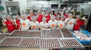 Volunteer Team members and students with disabilities spread warmth through the heart-shaped cookies.