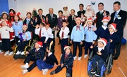 Jockey Club Steward Sir C K Chow (back row, 8th right) Executive Director, Charities, Douglas So (back row, 2nd right) and other officiating guests celebrate Christmas with the students. Teachers and students are thrilled by such a timely Christmas present from the Jockey Club.