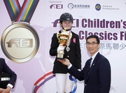 Club Steward and Vice-President of HKEF, Mr Michael Lee (right) presents the trophy to Hong Kong rider Arianna Ladd (left).