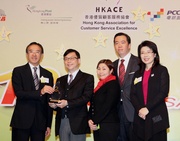 At todaya?s awards presentation ceremony, the Cluba?s Head of Telebet Services Peter Ng (2nd from left) receives the gold team award in the Contact Centre Service category, presented by James Tien, Chairman of the Hong Kong Tourism Board (1st from left) and Quince Chong, Chairman of the Hong Kong Association for Customer Service Excellence (1st from right). 