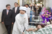 Club Chairman T Brian Stevenson and guests tour the existing Mianyang 3rd City Hospital, which is overcrowded.

