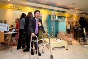 Elderly Commission Chairman Professor Alfred Chan tries the walking frame in the demonstration corner.
